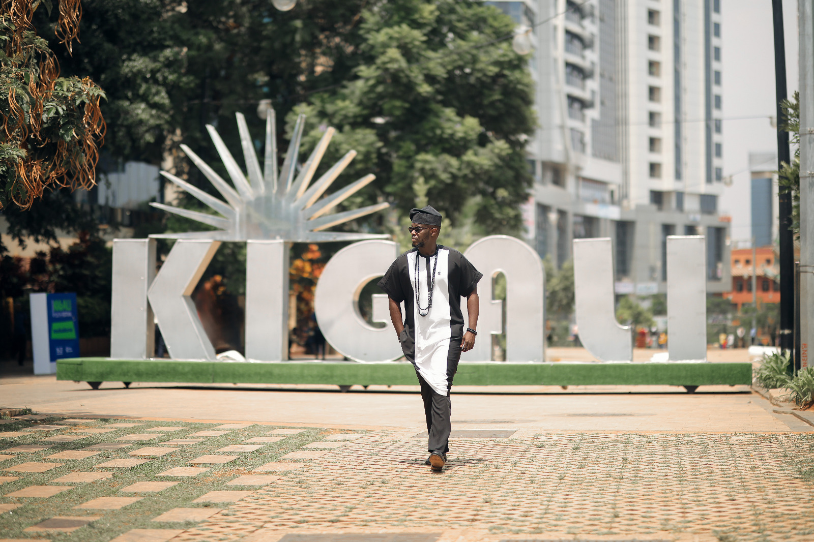 Black and white flowing dashiki with contrast panels and beads — bold Abuja cultural fashion.
