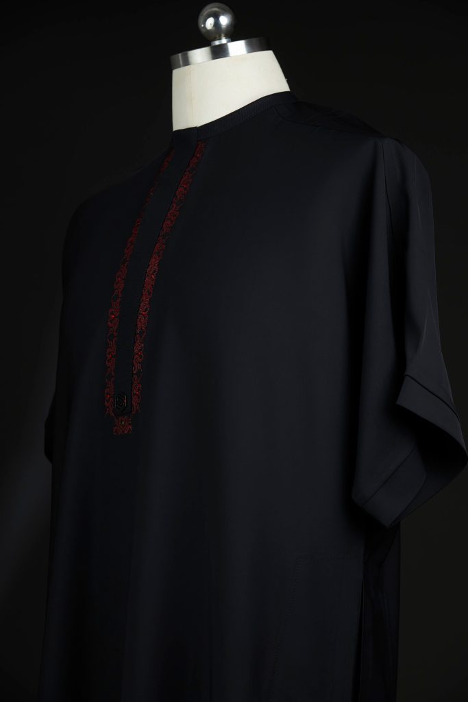 Close-up of blacck Soso Africa danshiki on mannequin showing embroidery details adorned with Swarov stones.